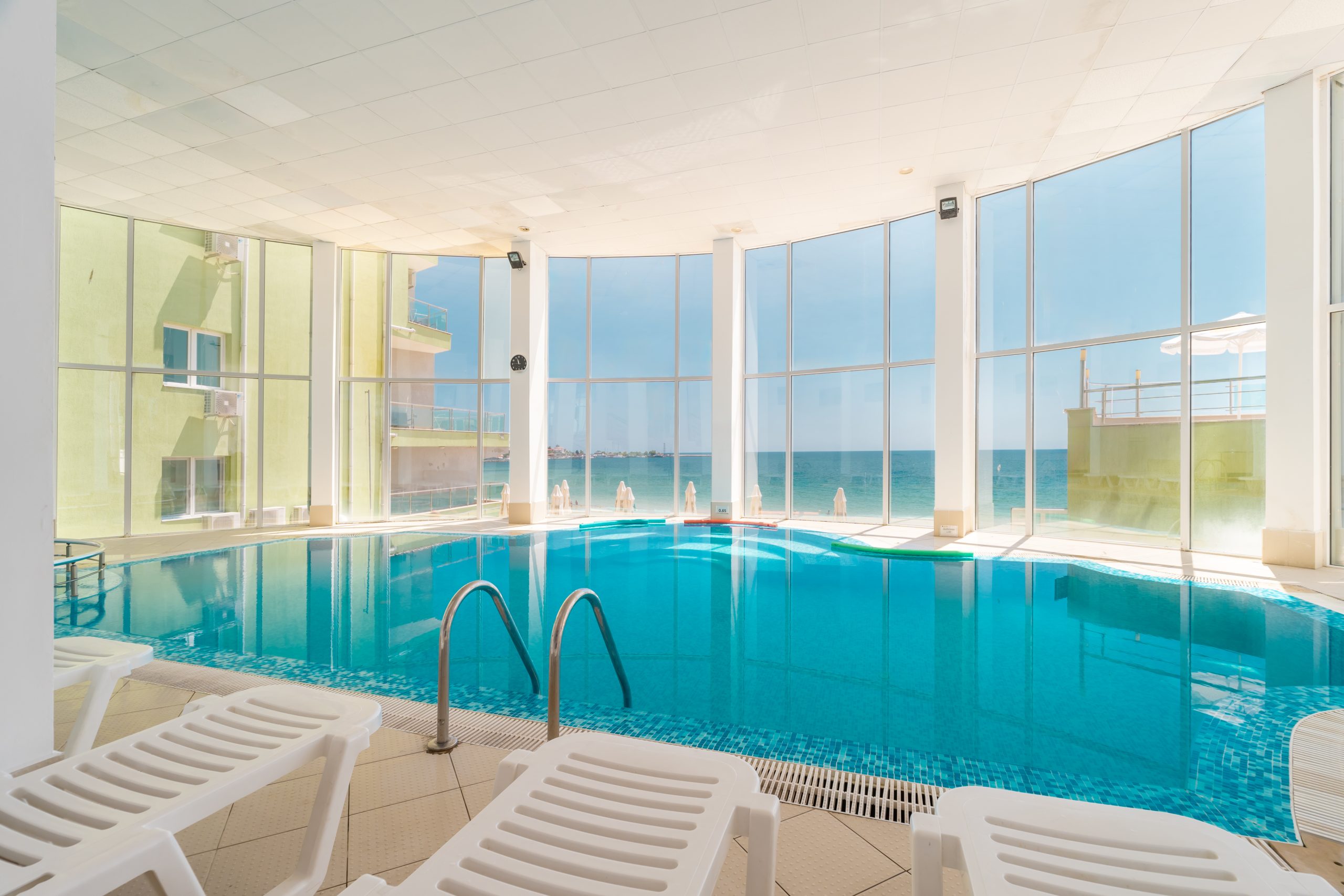 Indoor swimming pool and loungers at MPM Hotel Arsena